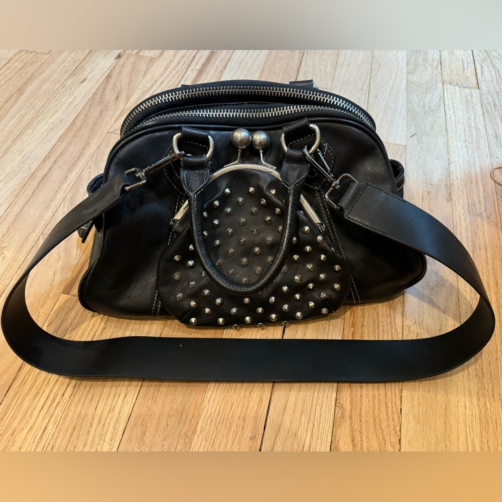 Black leather Betsy Johnson bowling bag with silver studs and hardware.